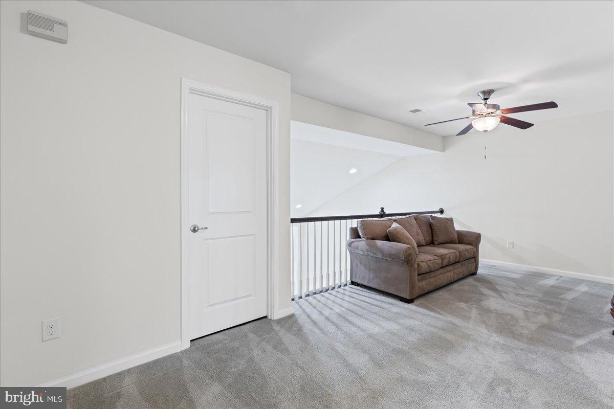 54 Heals Farm Road Burlington, NJ 08016 - Photo 18 of 26 a living room with furniture and a ceiling fan
