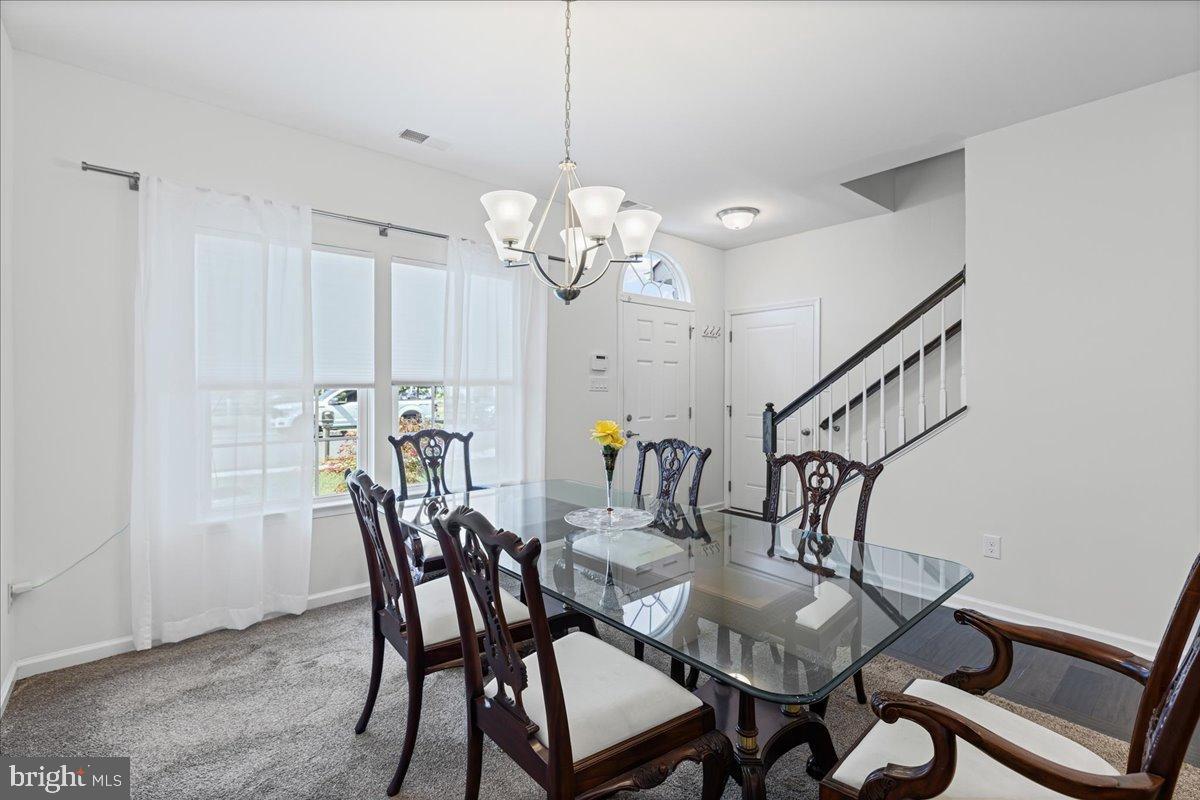 54 Heals Farm Road Burlington, NJ 08016 - Photo 5 of 26 a view of a dining room with furniture and wooden floor