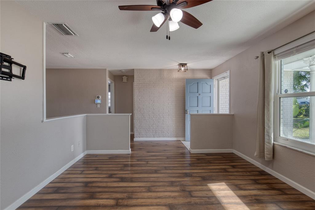 51 Rivocean Drive Ormond Beach, FL 32176 - Photo 11 of 65 a view of an empty room with wooden floor and a window