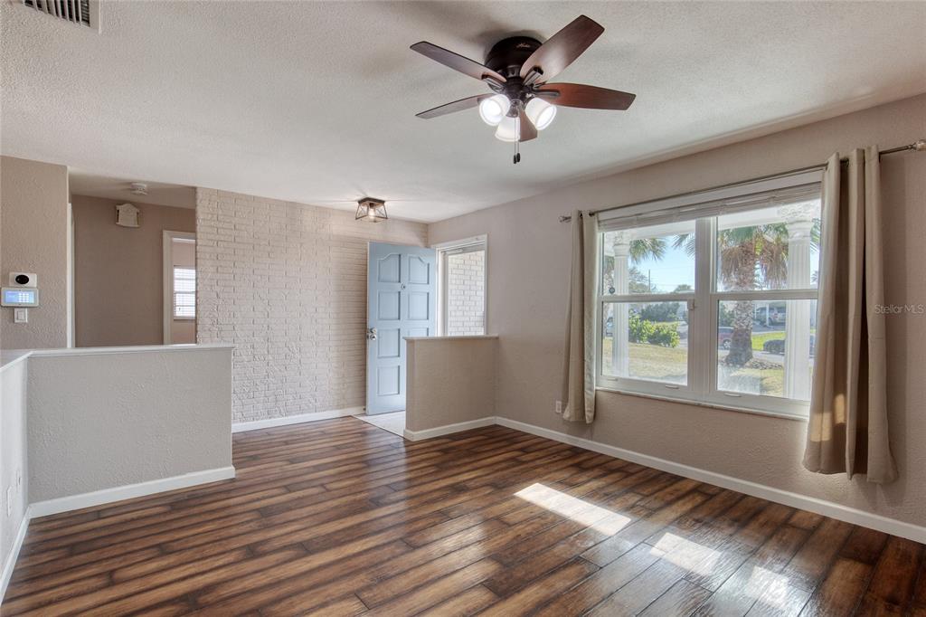 51 Rivocean Drive Ormond Beach, FL 32176 - Photo 12 of 65 a view of an empty room with wooden floor and a window