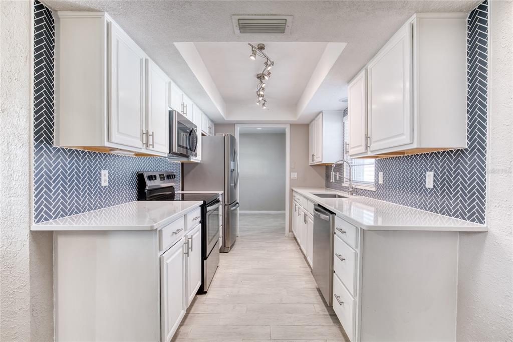 51 Rivocean Drive Ormond Beach, FL 32176 - Photo 17 of 65 a kitchen with stainless steel appliances granite countertop a sink a stove and a refrigerator