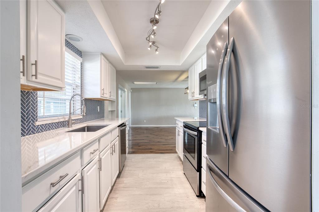 51 Rivocean Drive Ormond Beach, FL 32176 - Photo 19 of 65 a kitchen with stainless steel appliances granite countertop a refrigerator and a sink