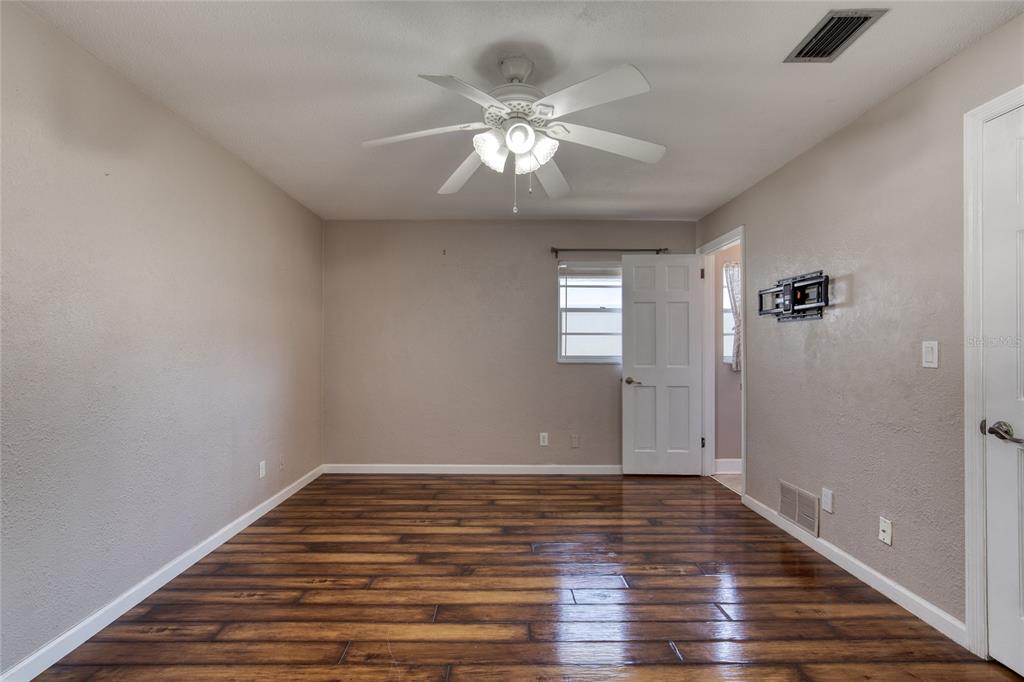 51 Rivocean Drive Ormond Beach, FL 32176 - Photo 36 of 65 a view of an empty room with wooden floor and a window