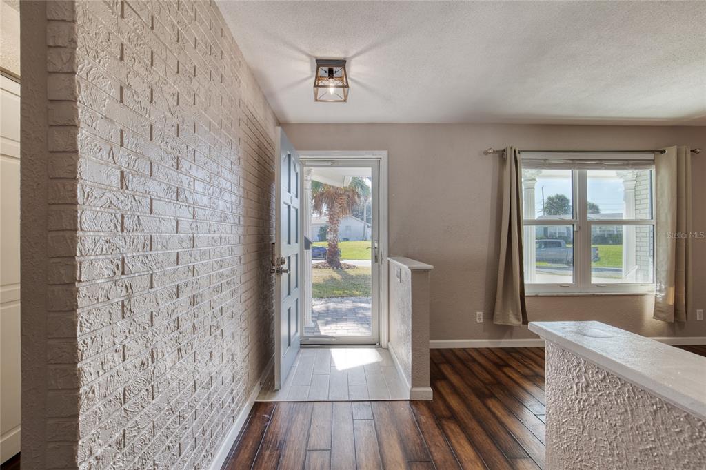 51 Rivocean Drive Ormond Beach, FL 32176 - Photo 7 of 65 a hallway with a wooden floor and a bed