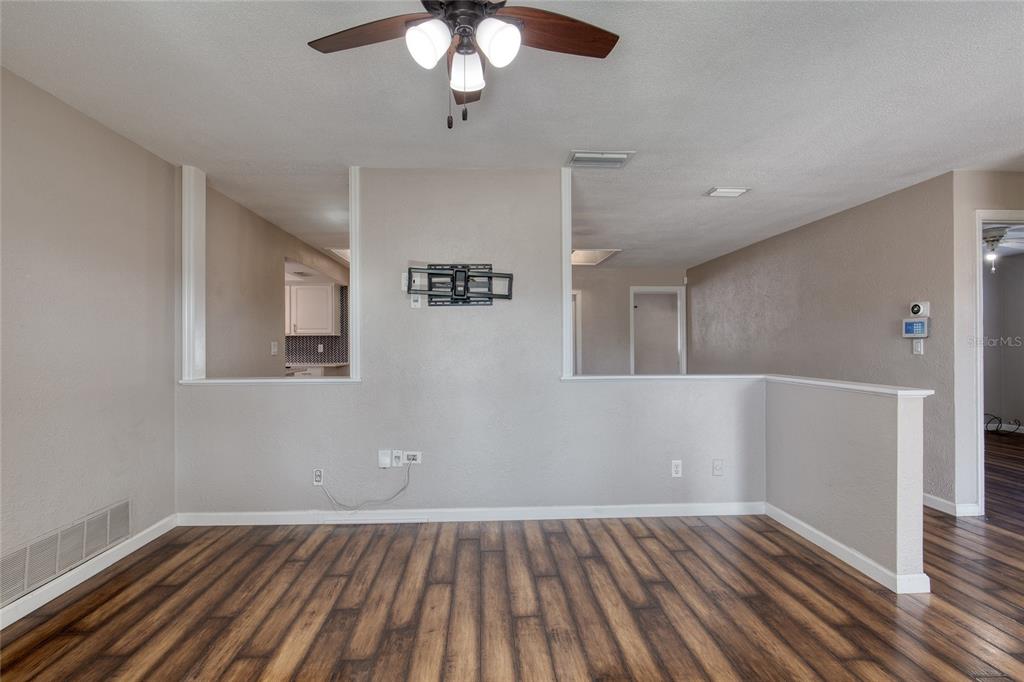 51 Rivocean Drive Ormond Beach, FL 32176 - Photo 10 of 65 a view of an empty room with wooden floor