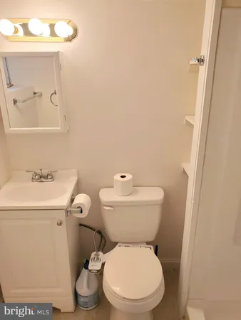 a white toilet sitting next to a bathroom sink