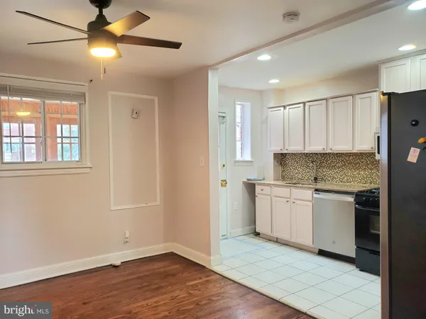 a kitchen with kitchen island granite countertop appliances cabinets and a sink