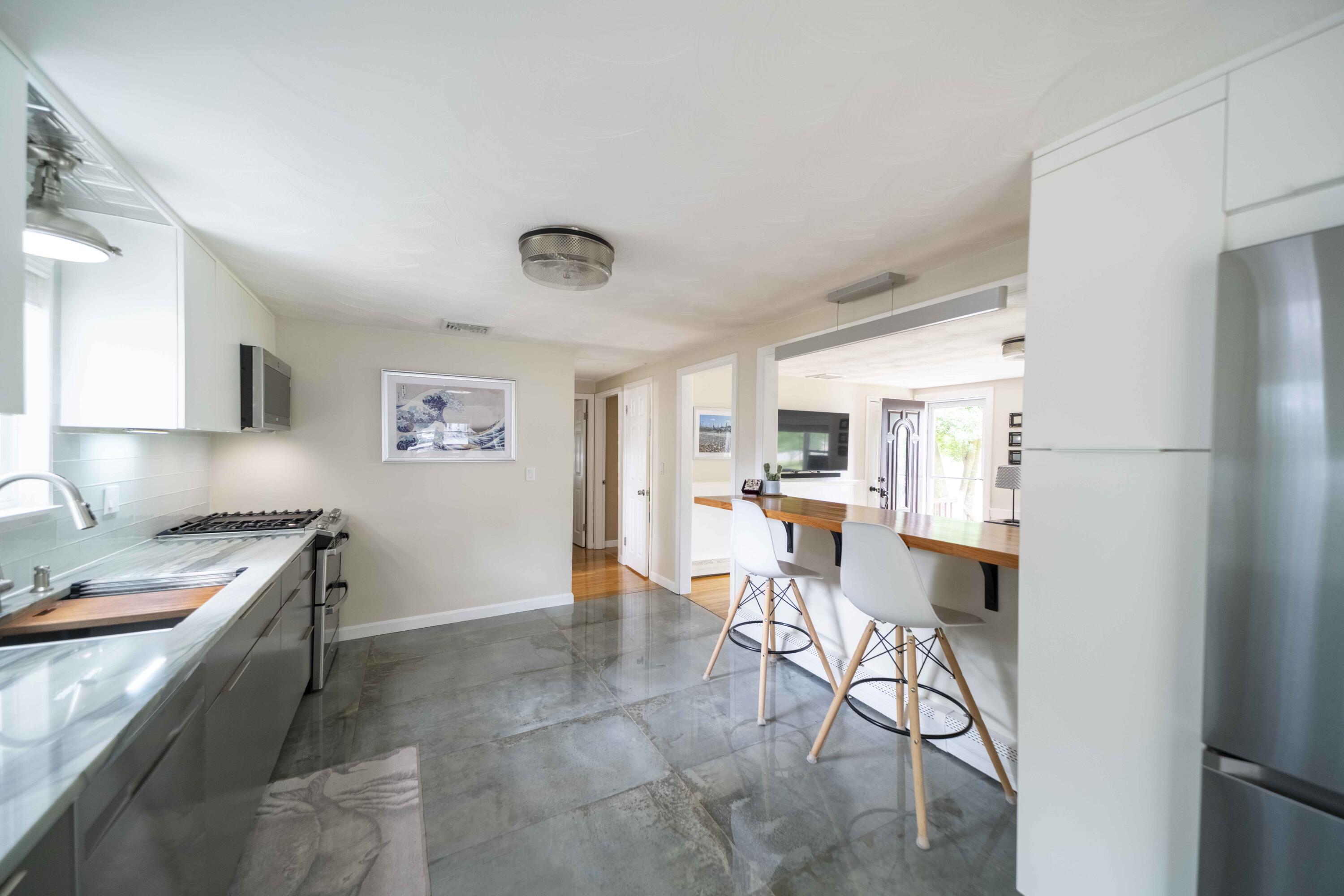 7 Arbeta Road Hyannis, MA 02601 - Photo 11 of 54 a kitchen with stainless steel appliances a table and chairs in it
