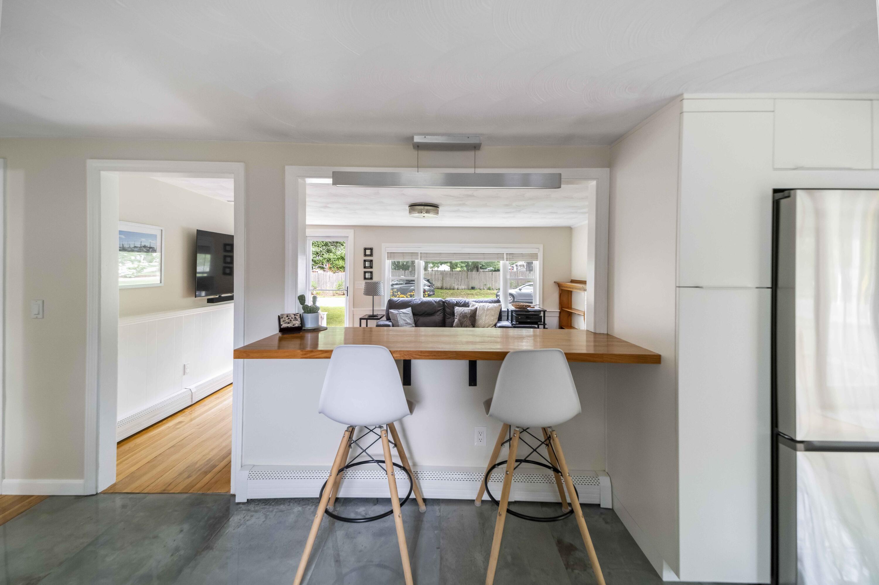 7 Arbeta Road Hyannis, MA 02601 - Photo 12 of 54 a kitchen with stainless steel appliances a dining table chairs and granite counter tops