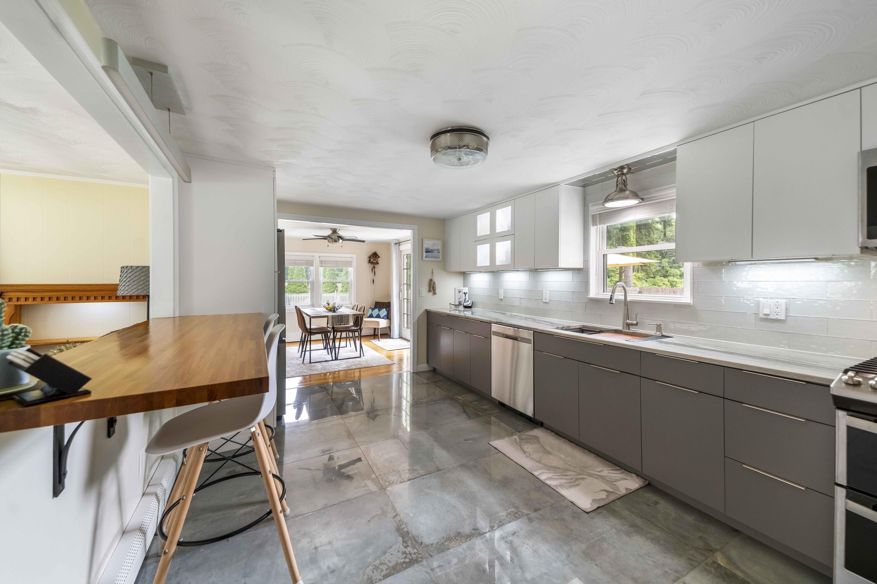 7 Arbeta Road Hyannis, MA 02601 - Photo 3 of 54 a kitchen with a table chairs sink and cabinets