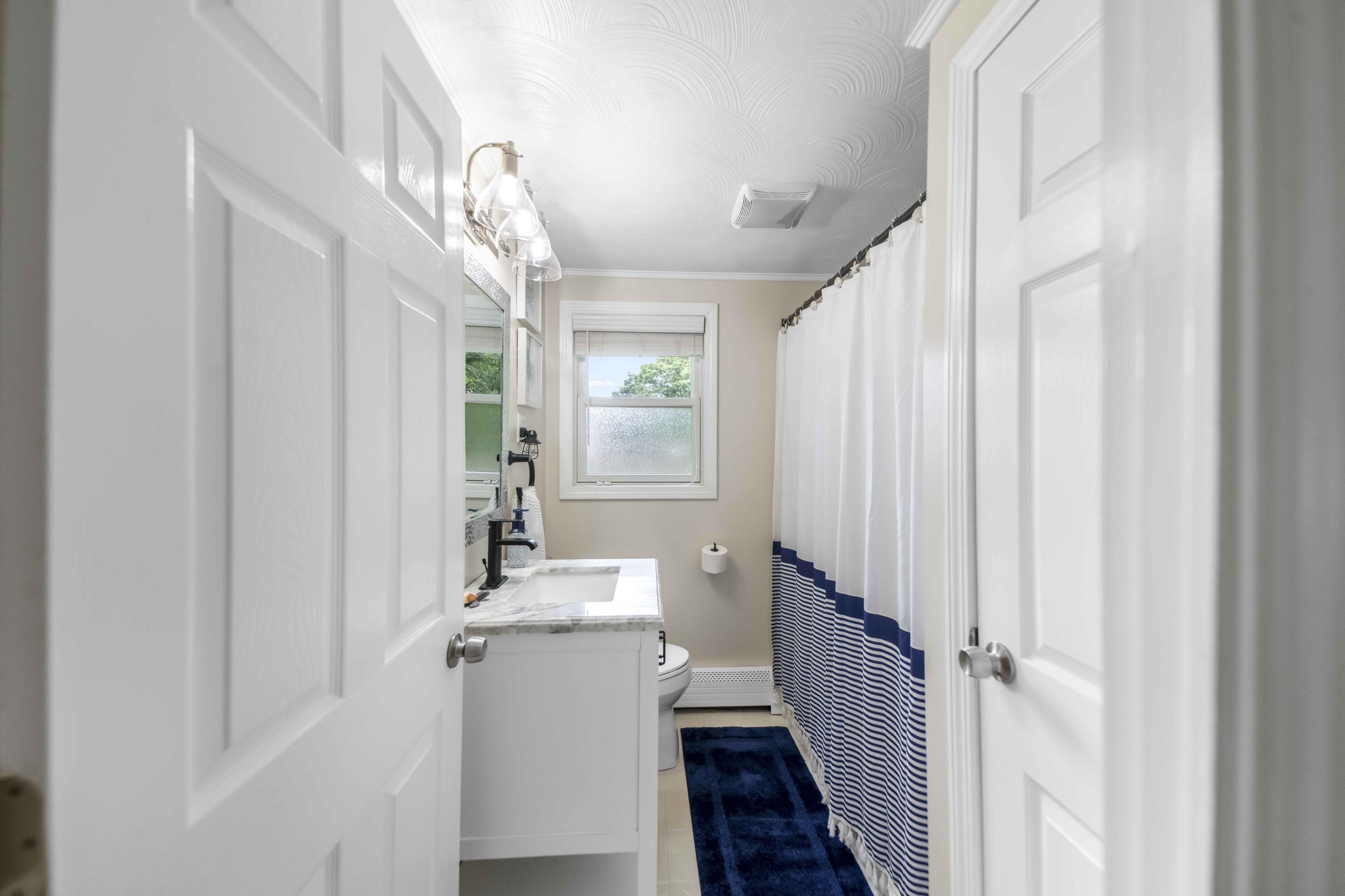 7 Arbeta Road Hyannis, MA 02601 - Photo 34 of 54 a bathroom with a sink a mirror and a window