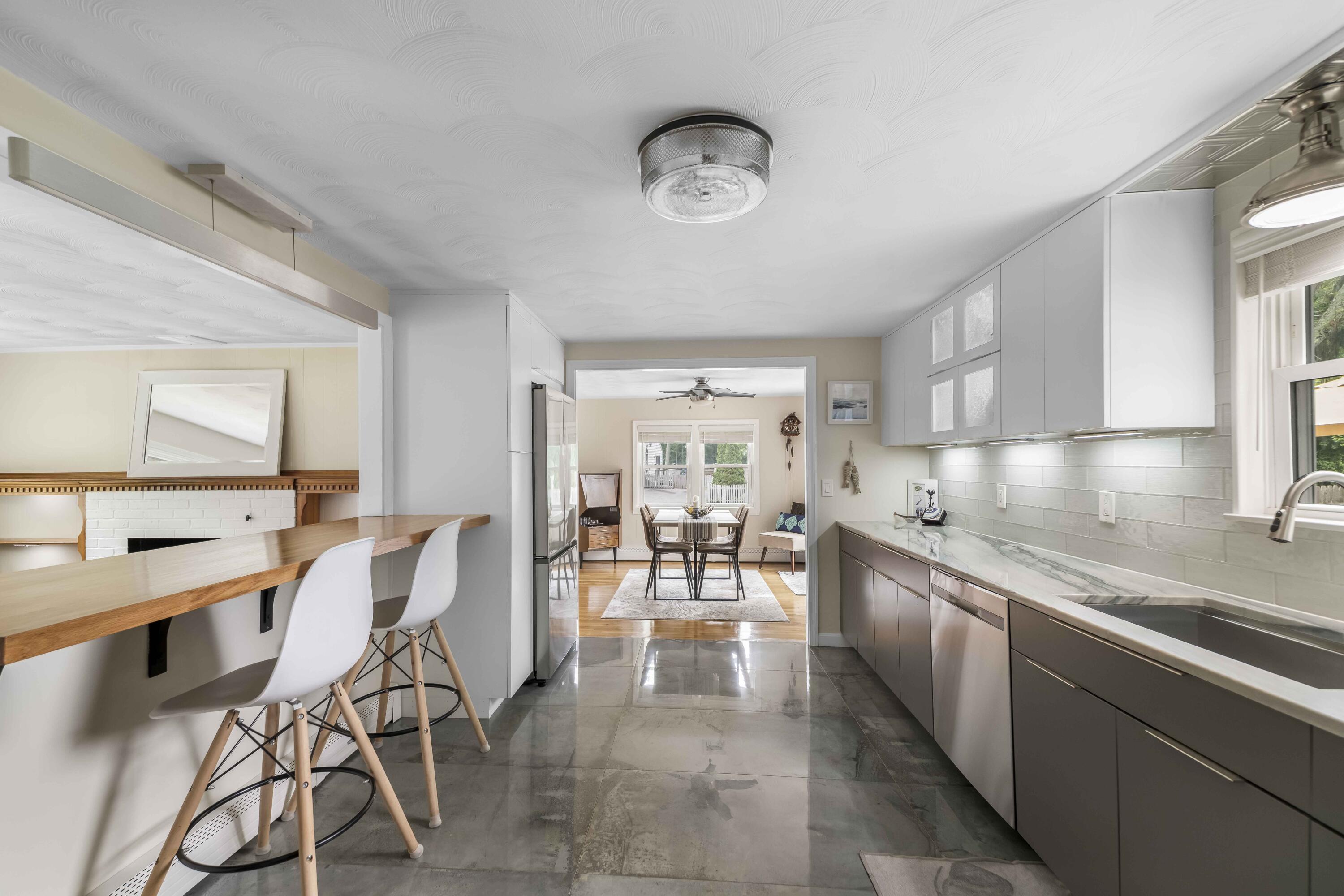 7 Arbeta Road Hyannis, MA 02601 - Photo 4 of 54 a large open kitchen with a large window and stainless steel appliances