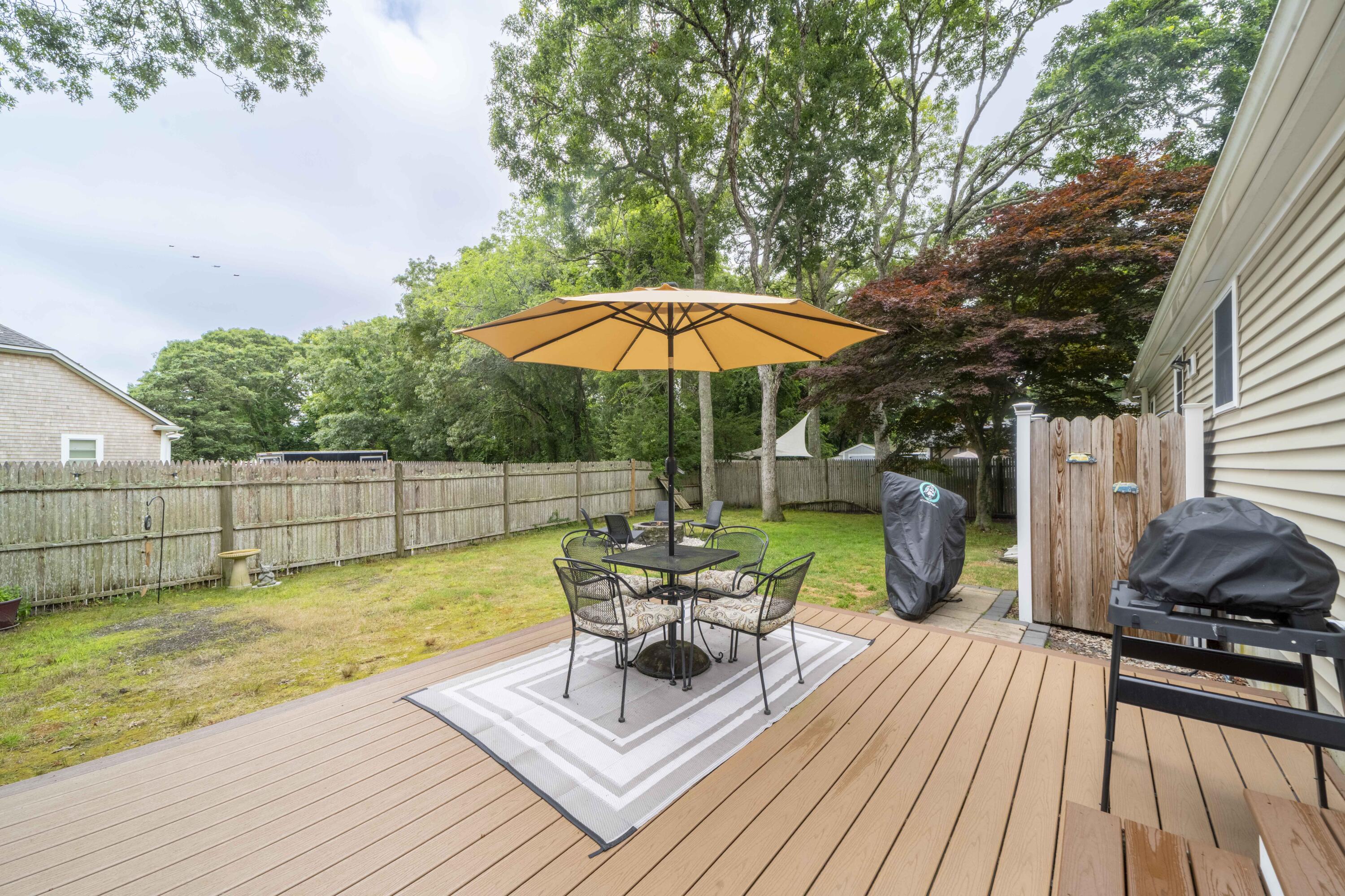7 Arbeta Road Hyannis, MA 02601 - Photo 42 of 54 a view of a patio with a table chairs and a barbeque