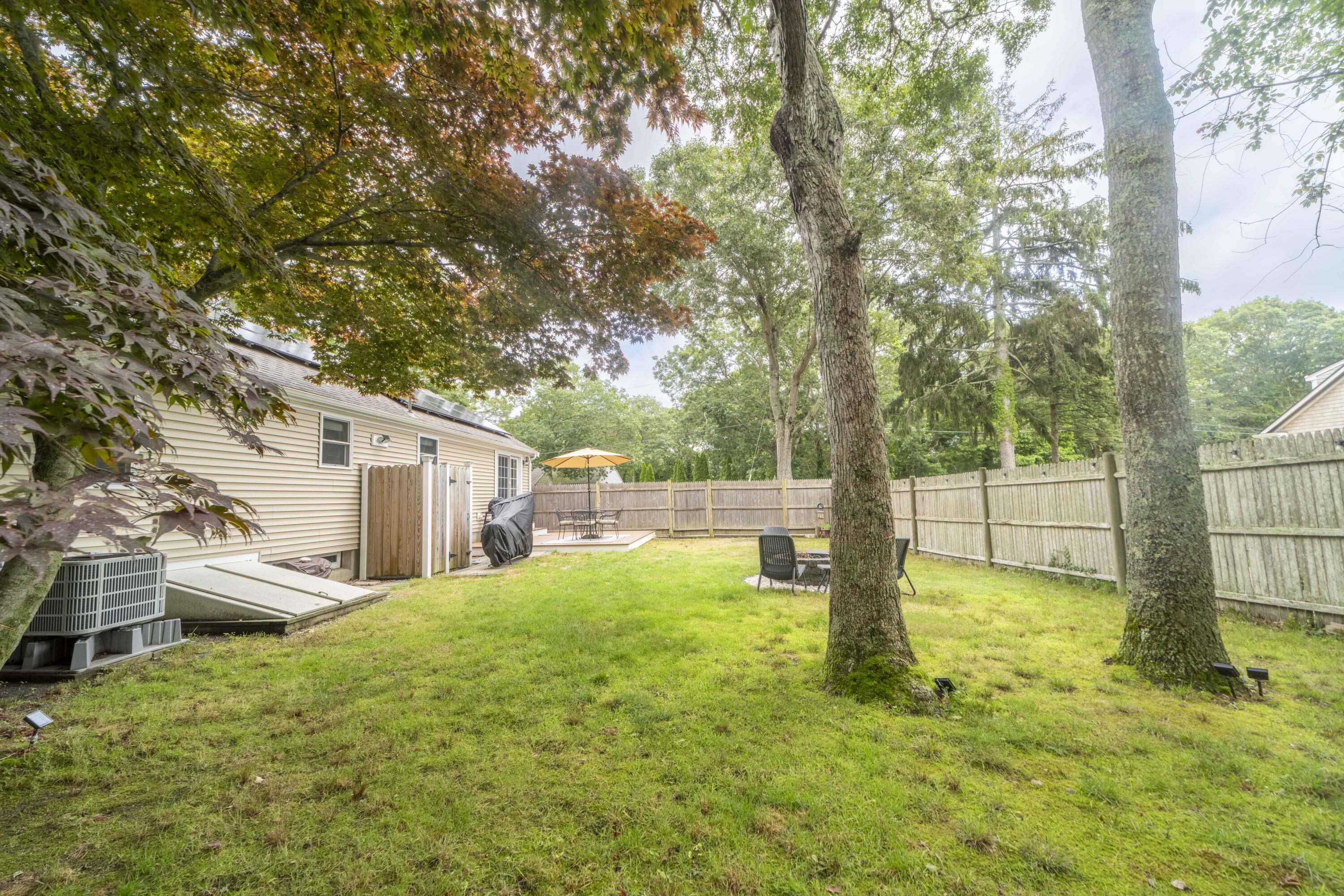7 Arbeta Road Hyannis, MA 02601 - Photo 45 of 54 a view of a backyard with large trees