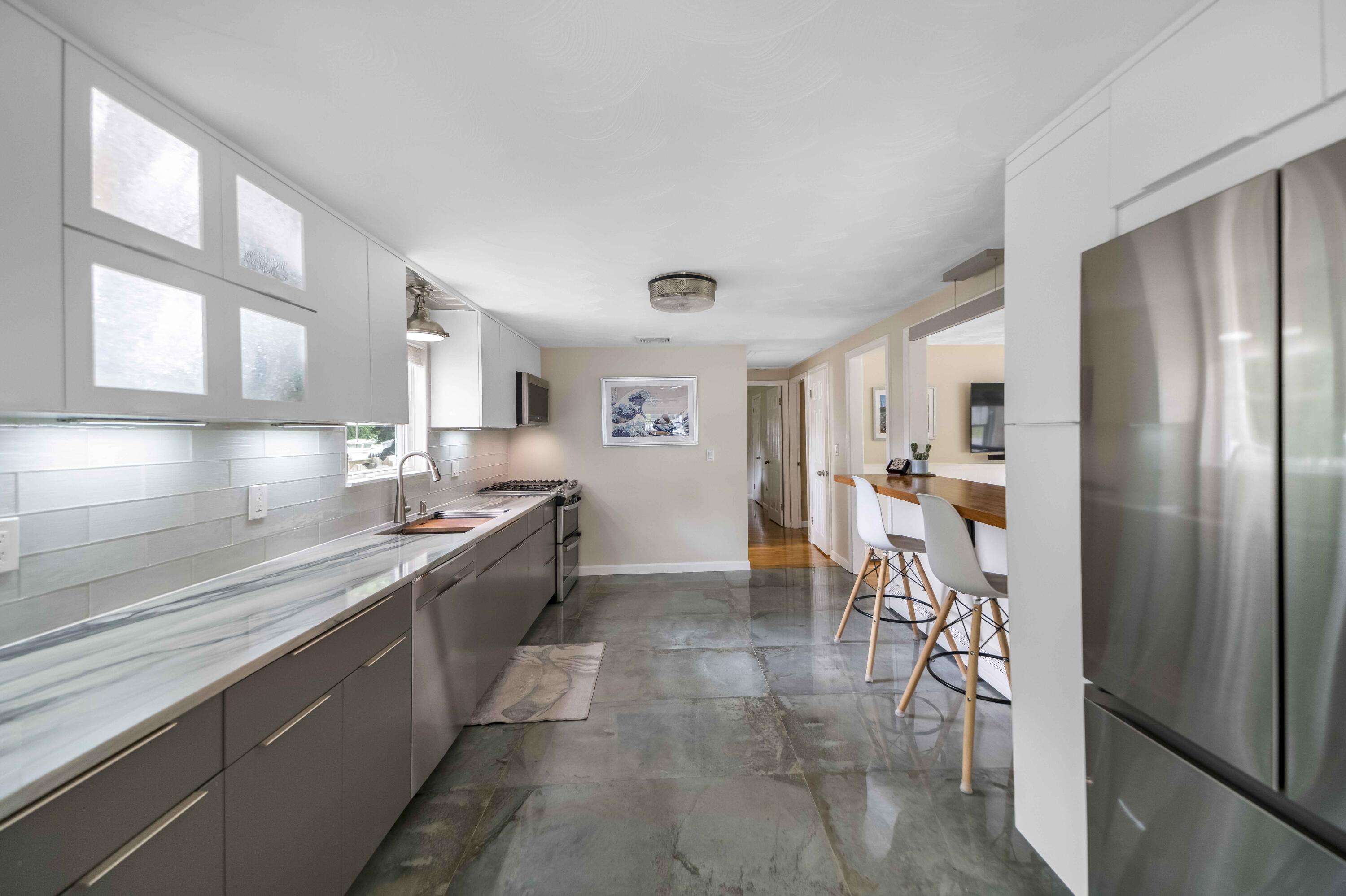 7 Arbeta Road Hyannis, MA 02601 - Photo 6 of 54 a large kitchen with stainless steel appliances kitchen island granite countertop a refrigerator and a sink
