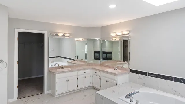a bathroom with a sink double vanity and a shower