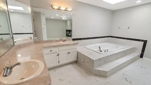 a bathroom with a sink double vanity and a mirror
