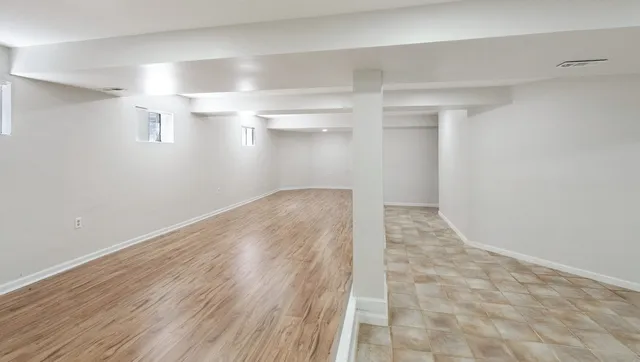 a view of a room with wooden floor