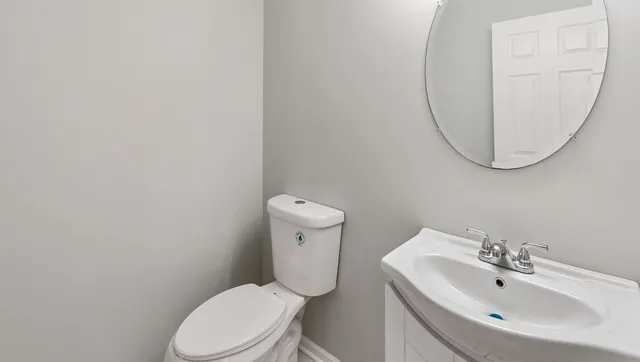 a white toilet sitting next to a bathroom sink