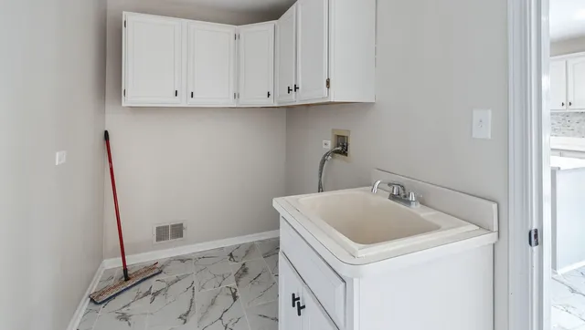 a utility room with a sink washer and dryer