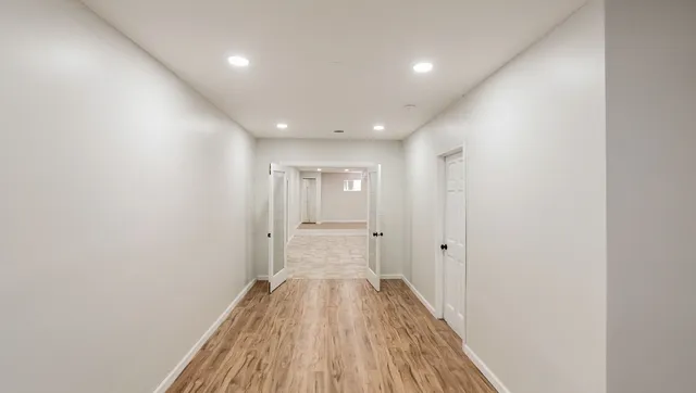 a view of a hallway with wooden floor