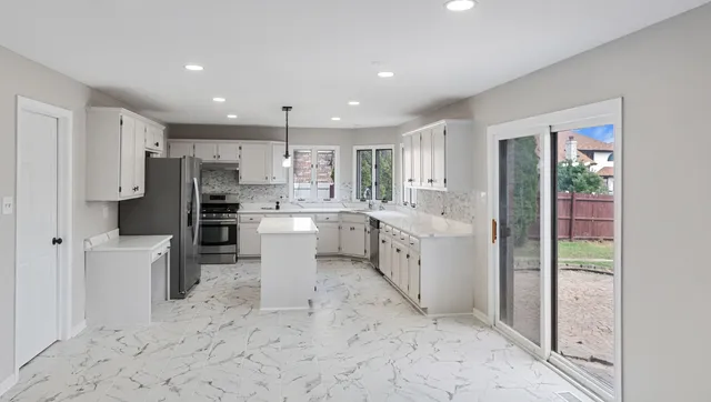 a kitchen with white cabinets and white appliances