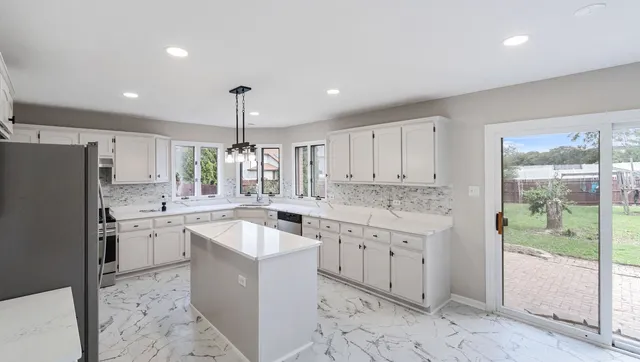 a kitchen with a sink stove and refrigerator