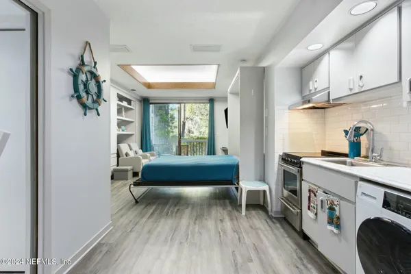 a bedroom with furniture and a wooden floor