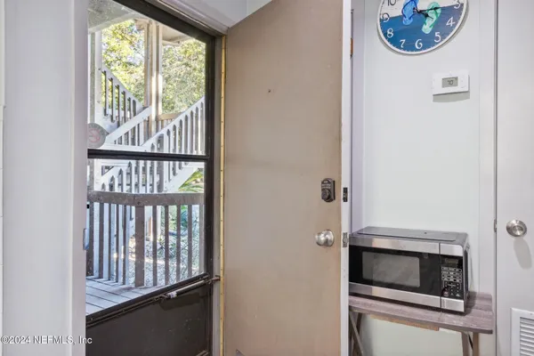 a view of a livingroom with furniture and front door