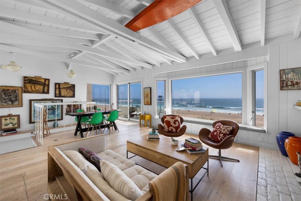 a living room with furniture a rug and a window