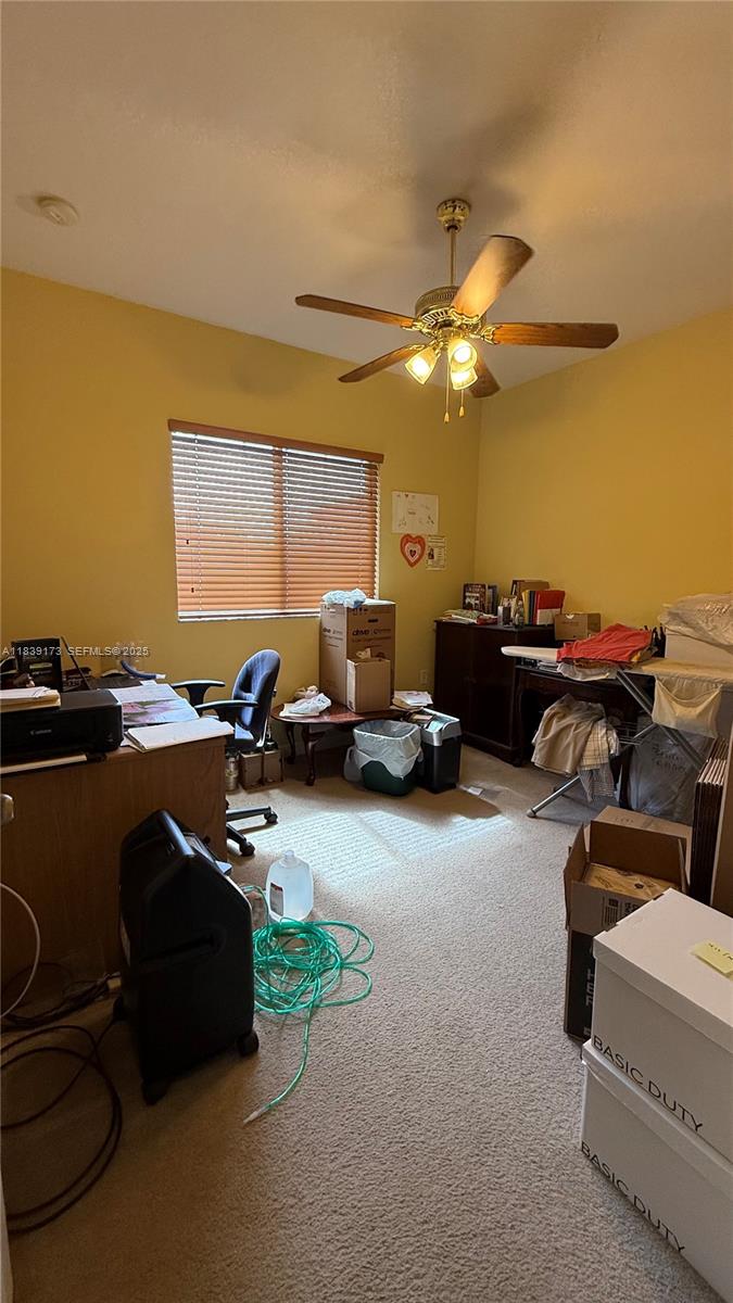 232 Southeast 32nd Terrace Homestead, FL 33033 - Photo 9 of 11 a gym room with furniture and a ceiling fan