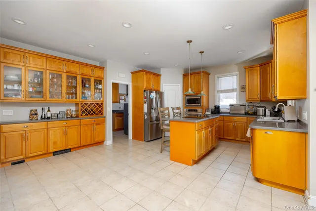 a large kitchen with large windows and stainless steel appliances