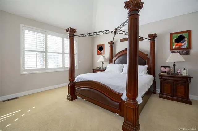 a bedroom with a bed window and dresser