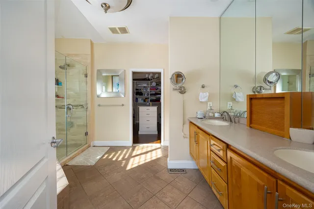 a spacious bathroom with a tub sink and shower