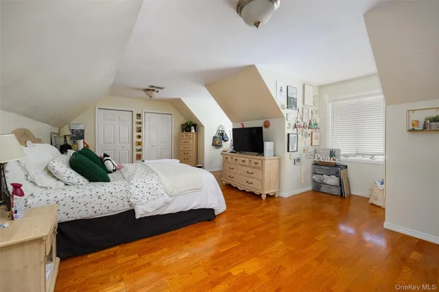 a bedroom with a large bed and a view of living room