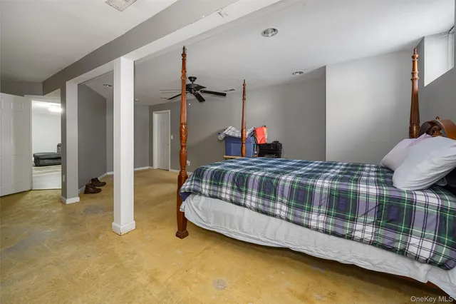 a bedroom with bed and a chandelier