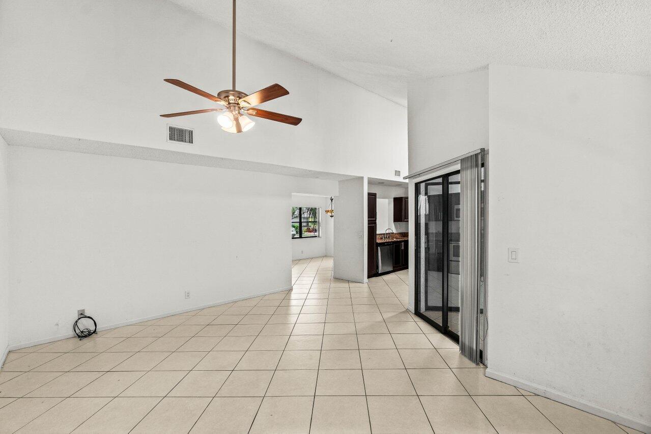 9308 Ketay Circle Boca Raton, FL 33428 - Photo 16 of 35 a view of a livingroom with a fireplace and a chandelier fan