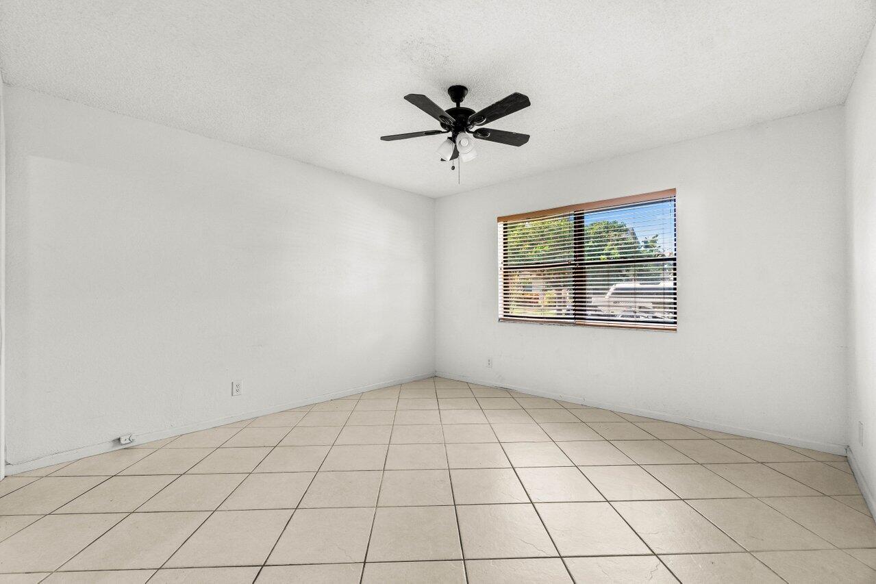 9308 Ketay Circle Boca Raton, FL 33428 - Photo 17 of 35 an empty room with windows and ceiling fan