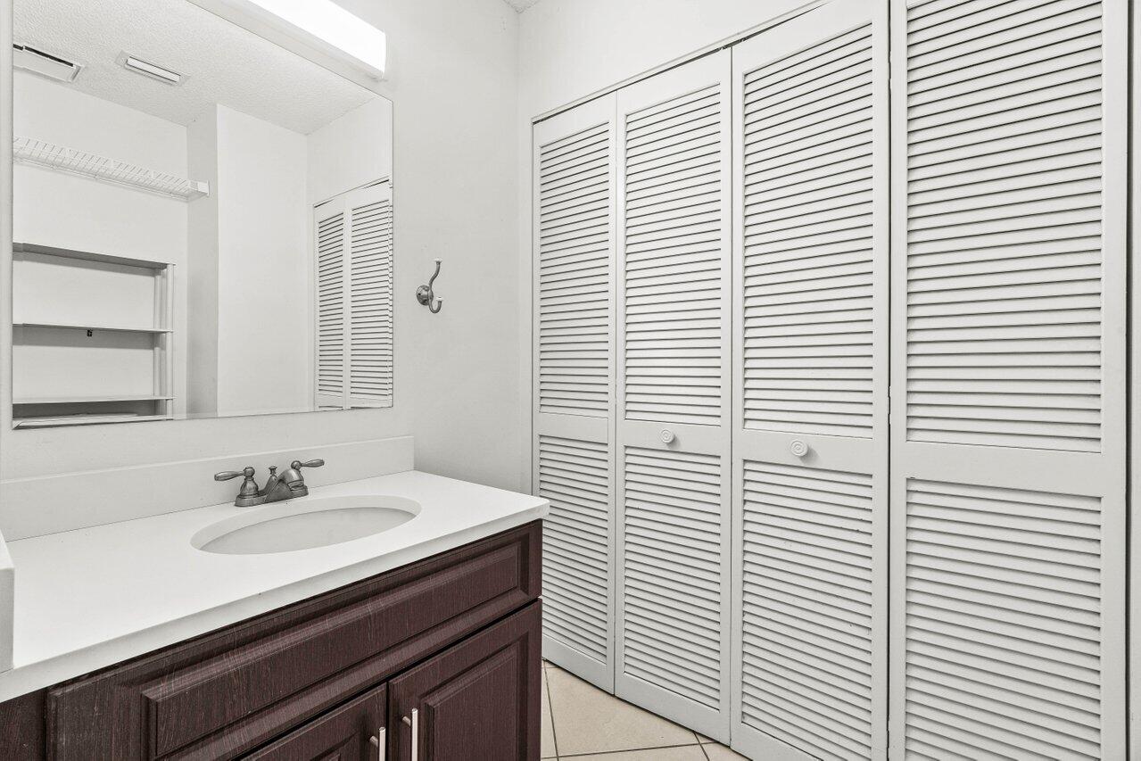 9308 Ketay Circle Boca Raton, FL 33428 - Photo 21 of 35 a bathroom with a sink and a mirror