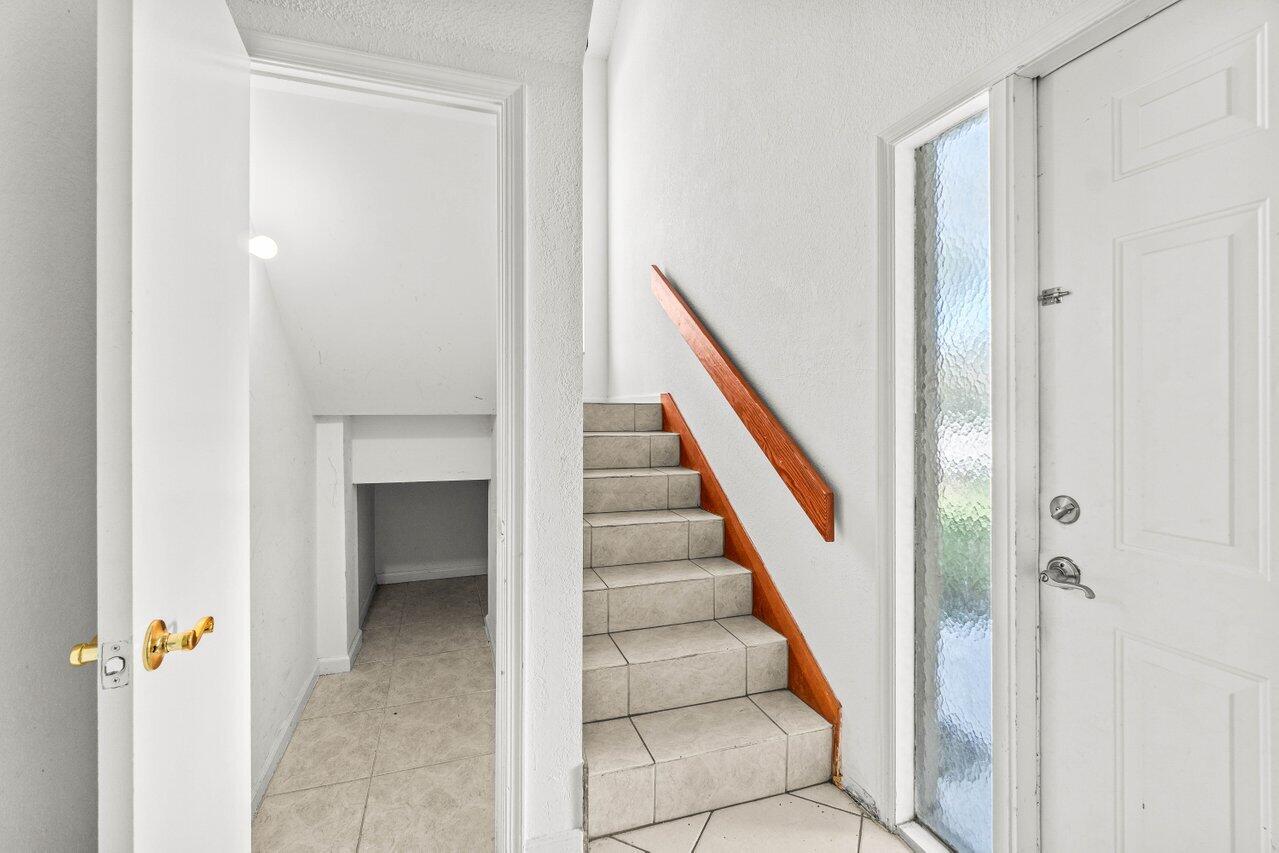 9308 Ketay Circle Boca Raton, FL 33428 - Photo 23 of 35 a view of a hallway with wooden floor and staircase