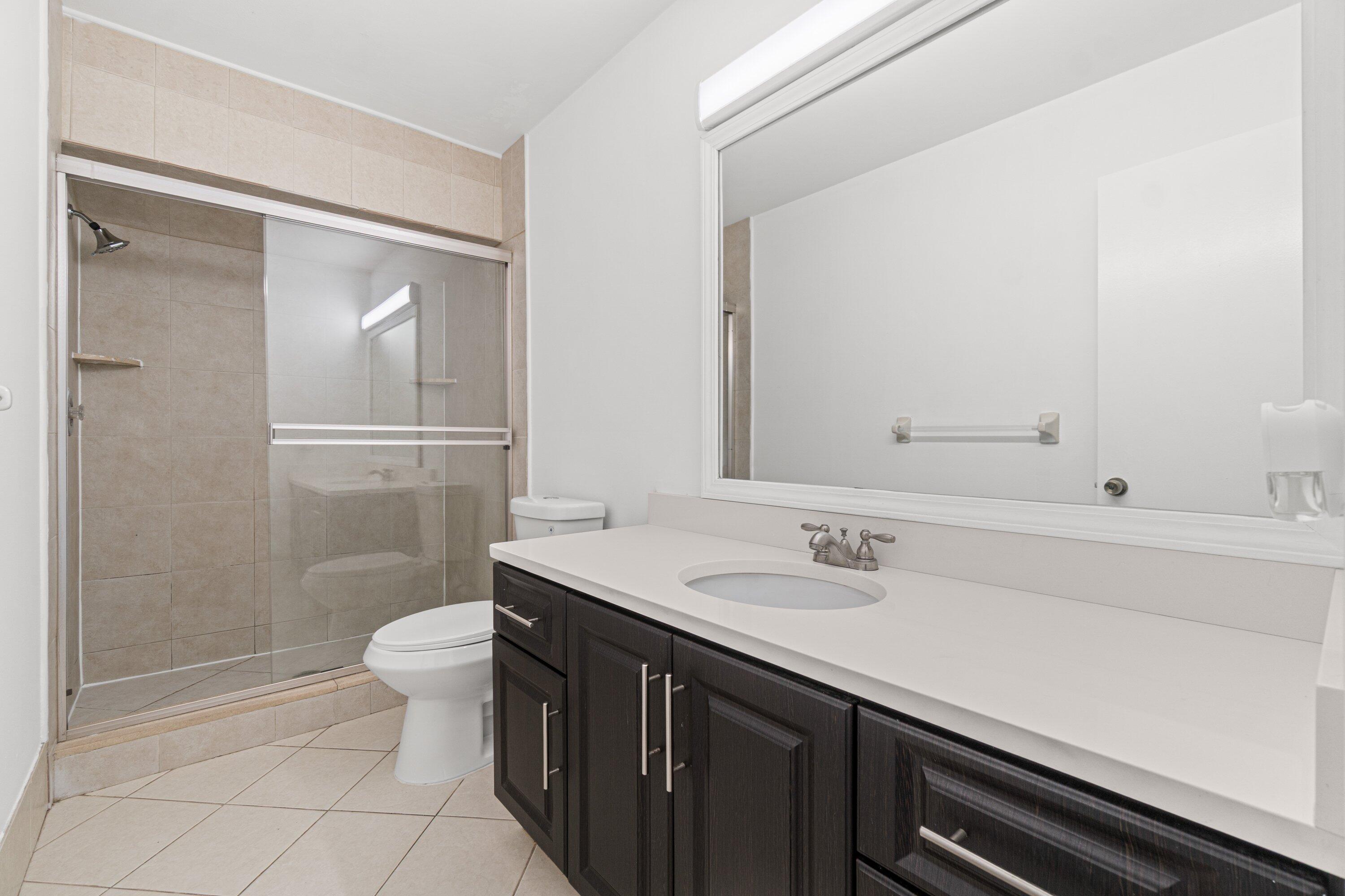 9308 Ketay Circle Boca Raton, FL 33428 - Photo 28 of 35 a bathroom with a sink a toilet and shower