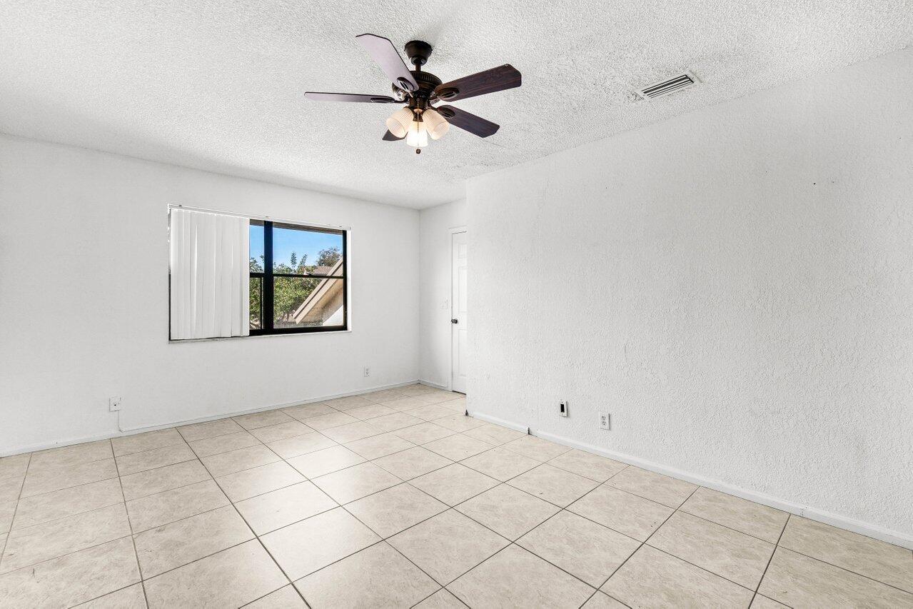 9308 Ketay Circle Boca Raton, FL 33428 - Photo 29 of 35 a view of empty room with a ceiling fan