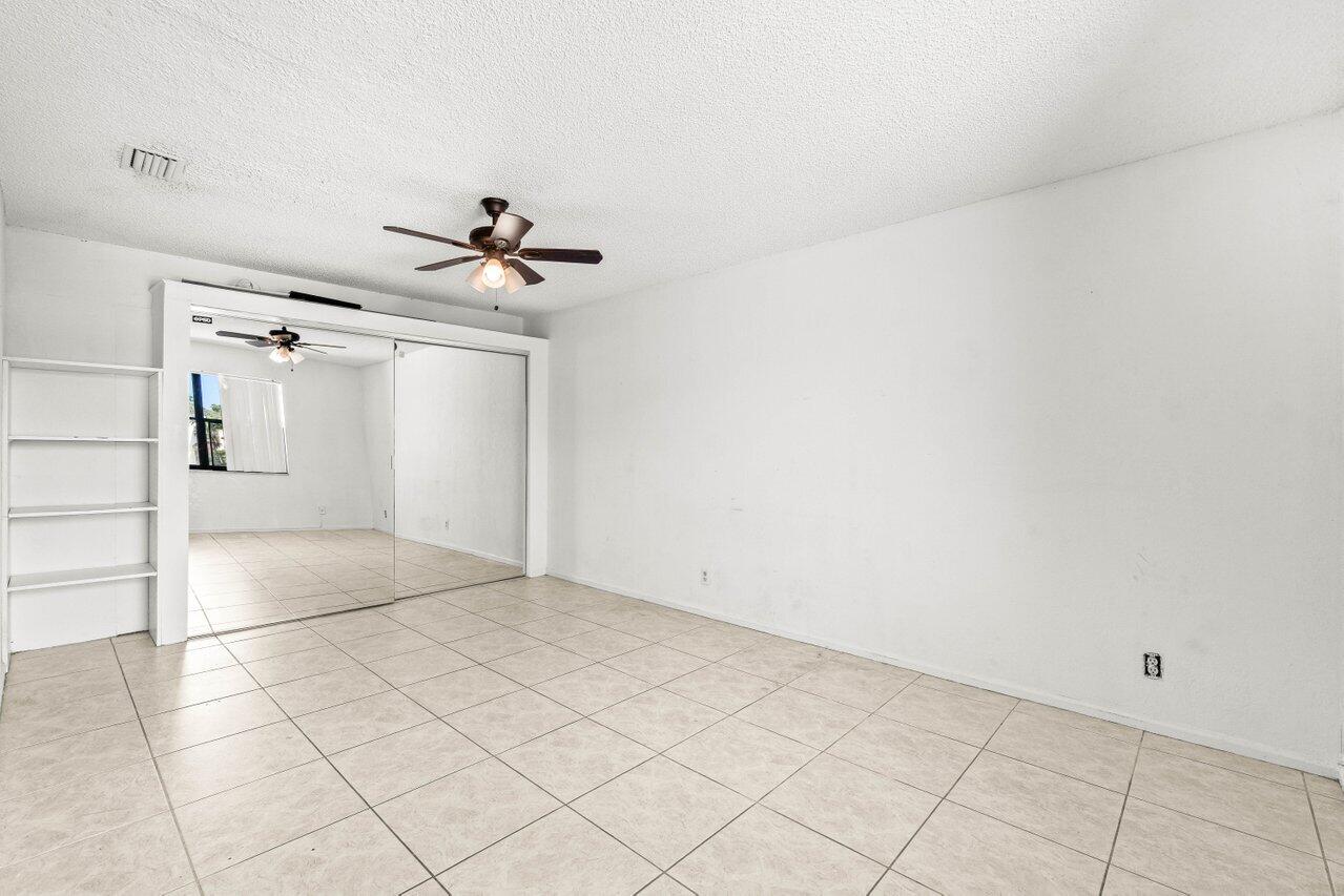 9308 Ketay Circle Boca Raton, FL 33428 - Photo 30 of 35 a view of a livingroom with a ceiling fan and carpet