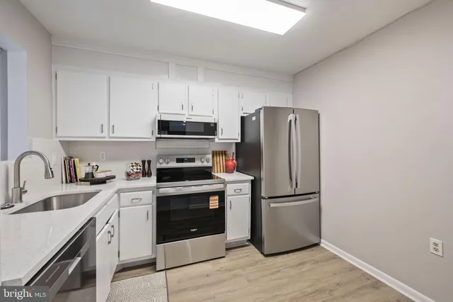 a kitchen with a sink a stove and refrigerator