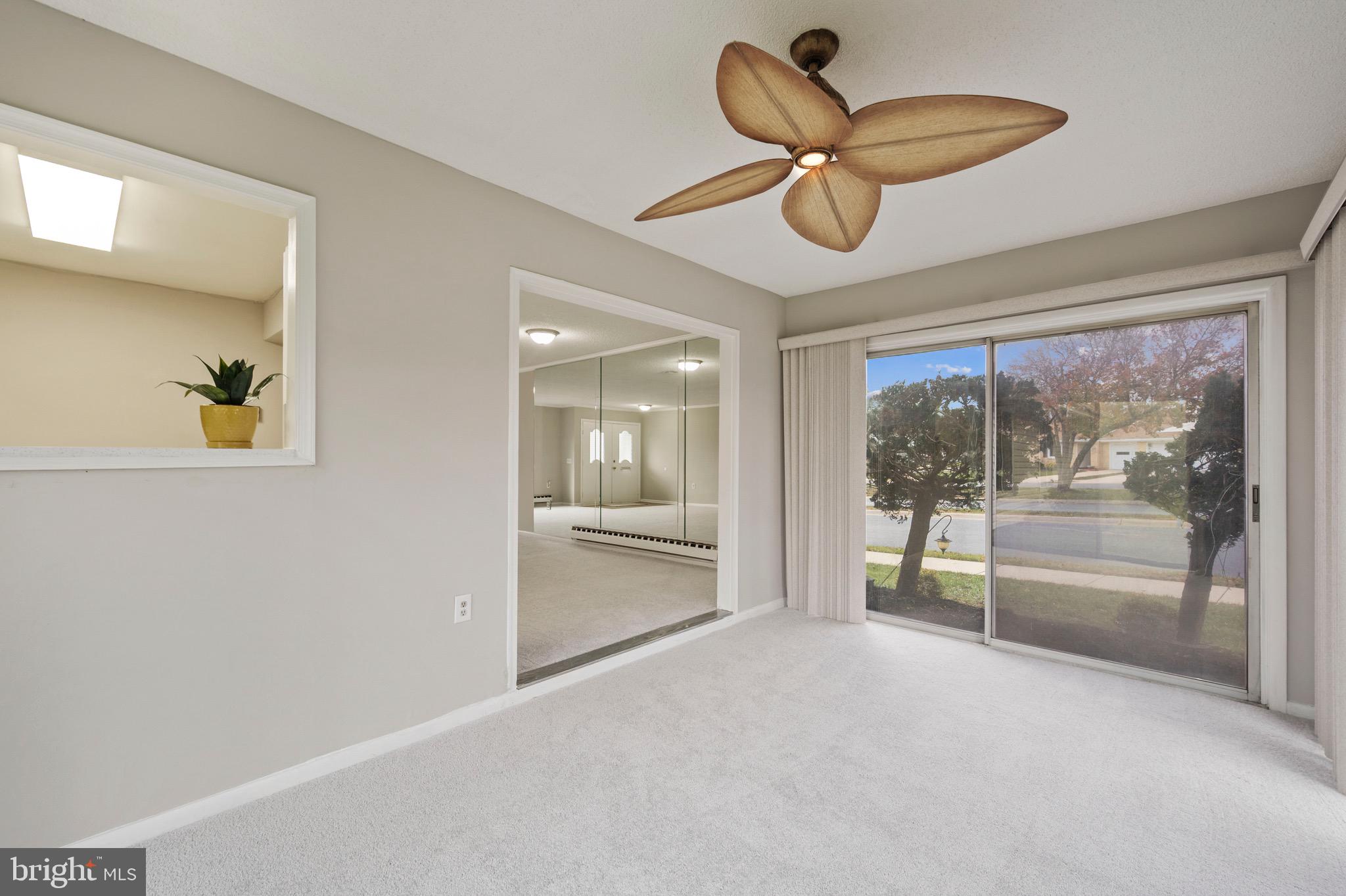 15561 Prince Frederick Way, Unit 114A Silver Spring, MD 20906 - Photo 15 of 32 a living room with furniture and a large window