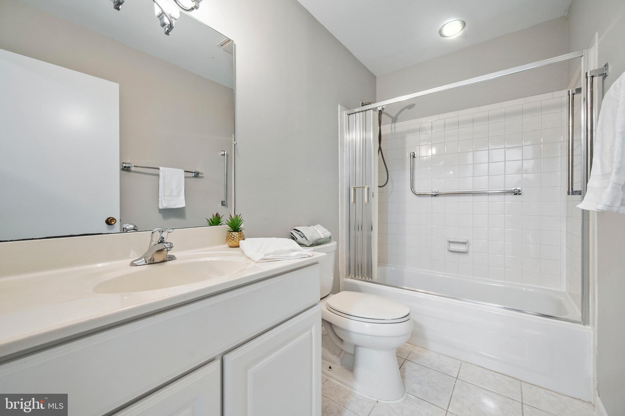 15561 Prince Frederick Way, Unit 114A Silver Spring, MD 20906 - Photo 21 of 32 a bathroom with a sink toilet and shower