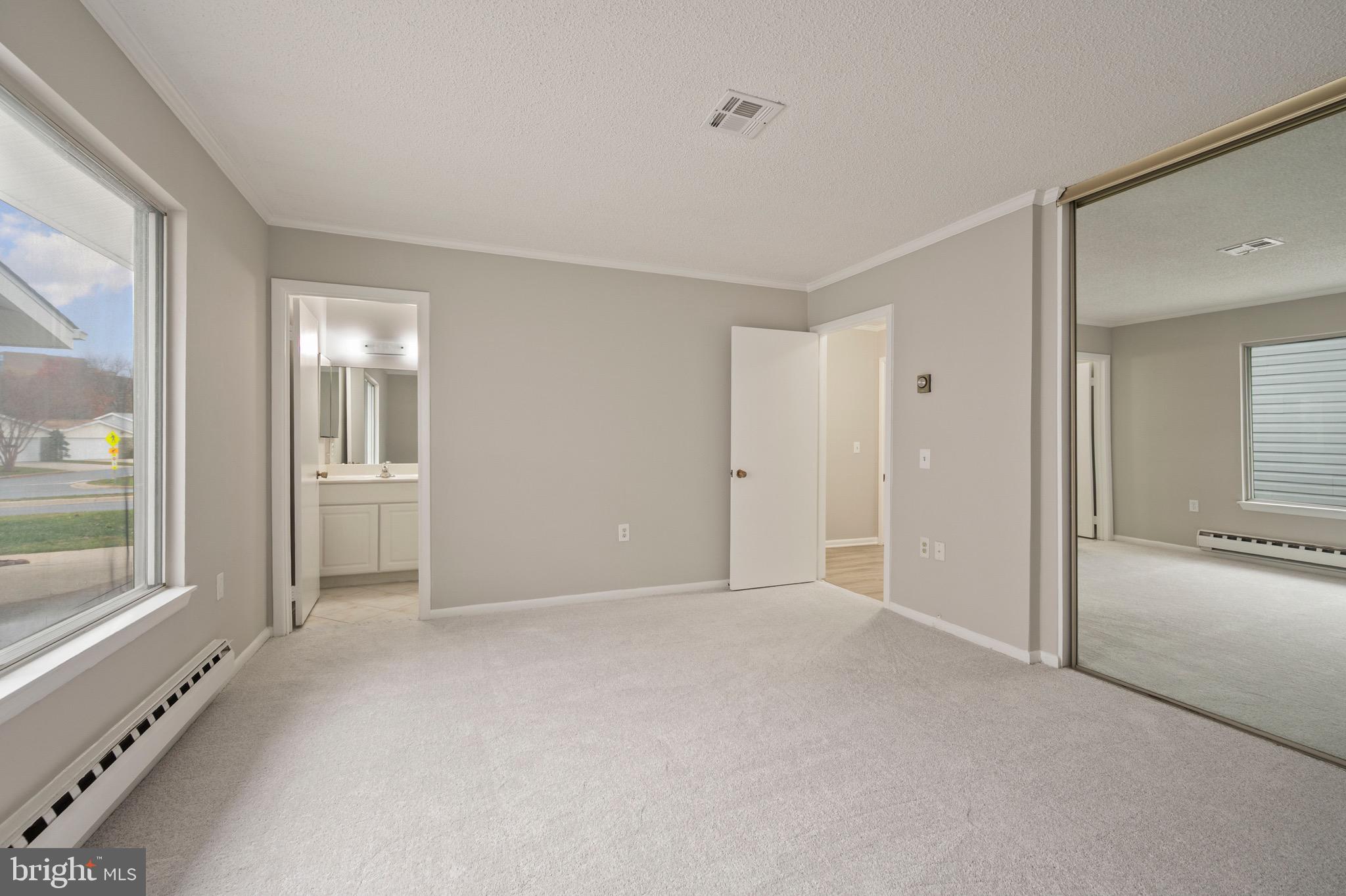 15561 Prince Frederick Way, Unit 114A Silver Spring, MD 20906 - Photo 25 of 32 a view of an empty room with glass door and windows