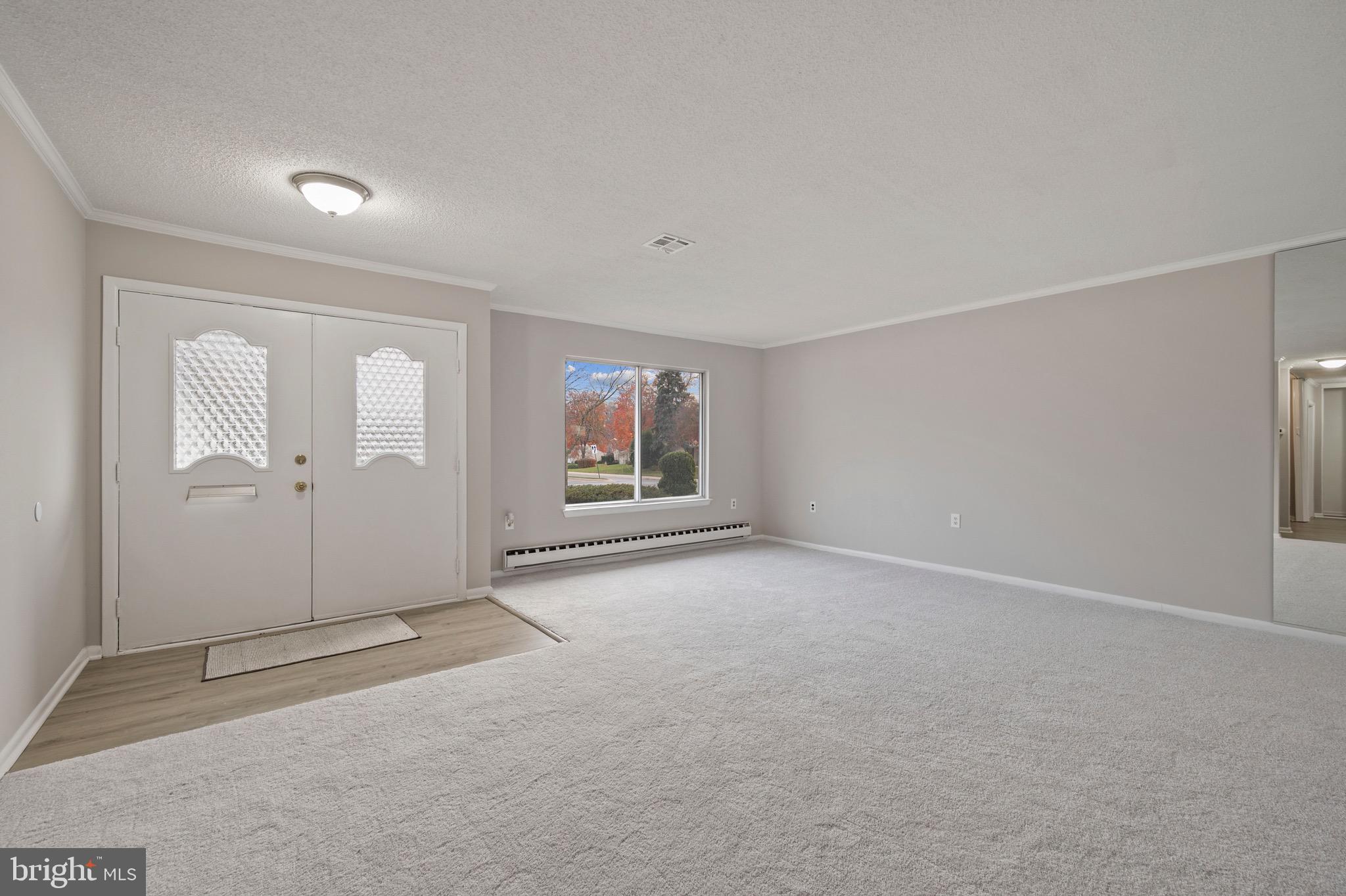 15561 Prince Frederick Way, Unit 114A Silver Spring, MD 20906 - Photo 8 of 32 an empty room with windows