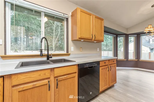 a kitchen with granite countertop a sink and a window