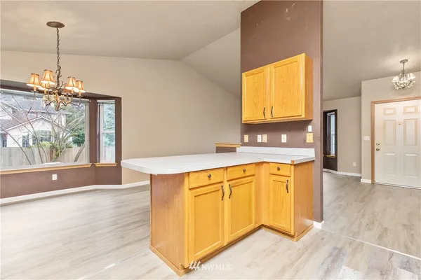 a view of a kitchen with a sink and a window